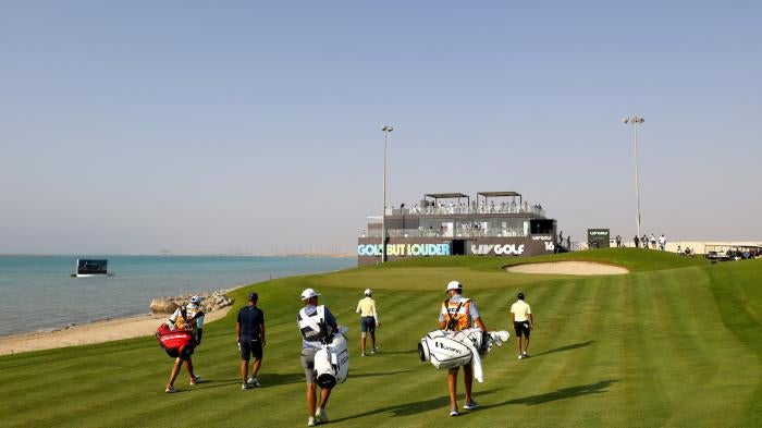 Golfers walk on the 16th hole during the LIV Golf Invitational at the Royal Greens Golf & Country Club in Saudi Arabia.