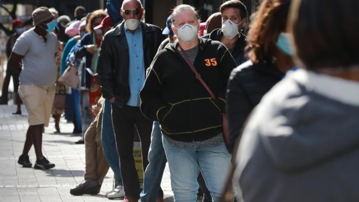 People standing in line to receive benefits at a South African Social Security Agency building in Cape Town, South Africa.