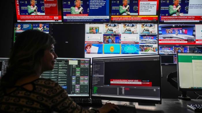 Screens from simultaneous broadcasts by different news channels display Turkish President Recep Tayyip Erdoğan, top, speaking during a rally in the eastern city of Van, on May 5, 2023. Photo taken at Halk TV headquarters.