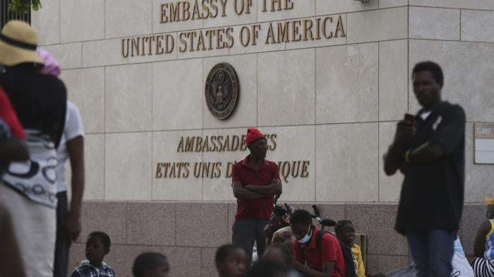 People displaced by armed gangs from their homes in the Tabare neighborhood rest outside the U.S. embassy in Port-au-Prince, Haiti, July 25, 2023. 