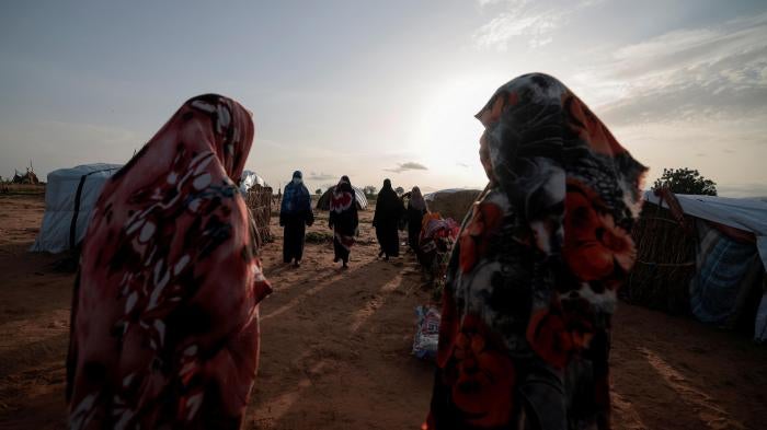  Survivors of sexual violence, who fled the fighting in El Geneina, in Sudan’s Darfur region, outside their makeshift shelters in Adre, Chad, August 1, 2023. © 2023 REUTERS/Zohra Bensemra