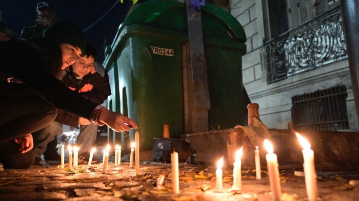 People light candles during a vigil on May 8, 2024, in front of the house where three lesbian women were killed following an attack in Buenos Aires.
