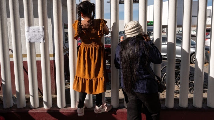 Asylum seekers wait for news on the CBP One appointments at El Chaparral crossing port in Tijuana, Baja California state, Mexico, on January 21, 2025. 