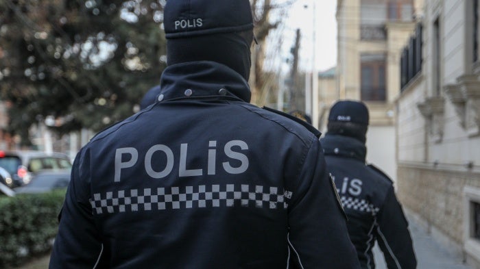 Police outside the building of Toplum TV, independent online media outlet, where law enforcement searched the offices and detained journalists, in Baku, Azerbaijan, March 6, 2024.