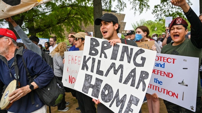 Protestors hold signs saying "Bring Kilmar Home" during a Free Kilmar Abrego and Hands Off protest. 