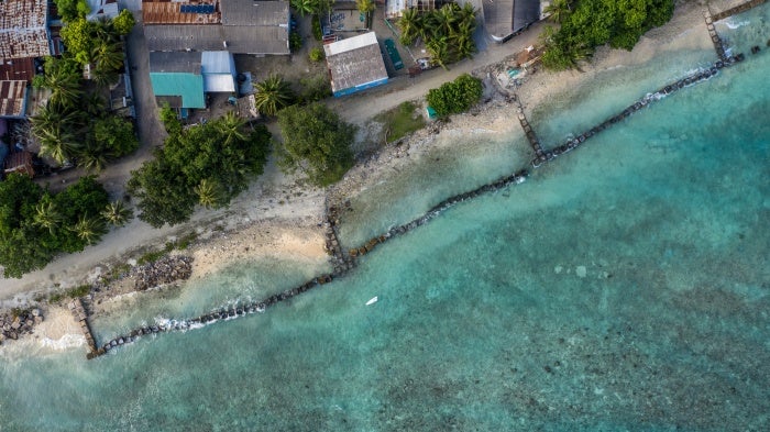 Concrete blocks are placed along the shoreline to try and prevent further coastal erosion in Mahibadhoo, Maldives, December 17, 2019.