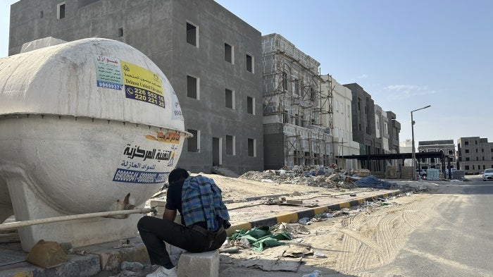 A construction worker washes his hands and face at the end of his working shift in Al Farwaniyah, Kuwait, August 8, 2024. 
