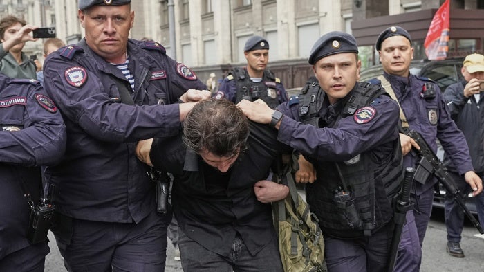 Police detain an activist in front of the State Duma, the lower house of the Russian parliament, in Moscow, Russia, July 22, 2025, before lawmakers approved a bill that punishes online searches for information that is deemed "extremist."