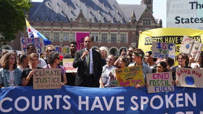 Ralph Regenvanu, Vanuatu's minister for climate change, speaks surrounded by demonstrators at the International Court of Justice ahead of an advisory opinion on what legal obligations nations have to address climate change in The Hague, Netherlands, July 23, 2025.