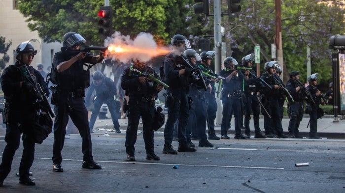 Los Angeles Police Department officers shoot kinetic impact projectiles at protesters outside City Hall  in Los Angeles, California, on June 8, 2025. © 2025 Apu Gomes/Getty Images
