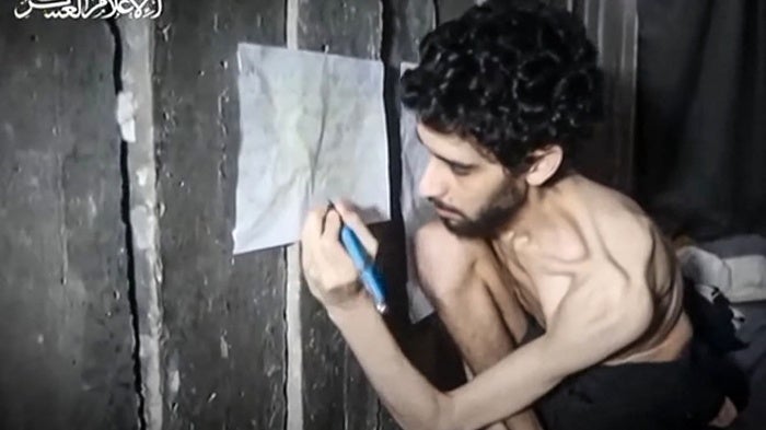 Screen grab of August 1, 2025 video published by Hamas’ armed wing showing emaciated 24-year-old Israeli hostage Evyatar David in a tunnel sitting next to a chart that he says tracks his extremely limited food intake.