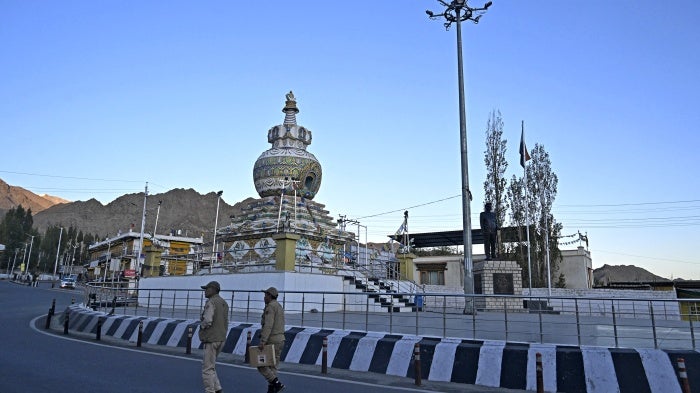 Indian policemen patrol a road in Leh on September 25, 2025. 