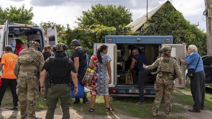 Policemen and medics help move people from an armored car to an ambulance in the village of Yarova,  Donetska region. On September 9, 2025, Yarova was hit by a Russian aerial strike, which killed dozens of civilians. 