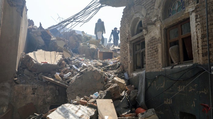 People inspect damage on September 13, 2025, in Sanaa, Yemen days after an Israeli strike hit the center of the city.