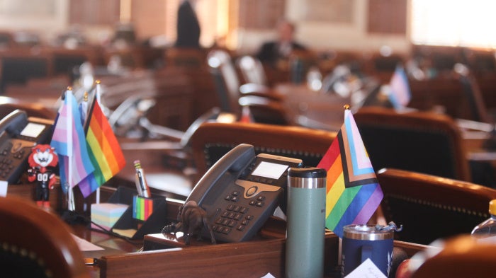 Transgender and LGBTQ rights flags sit on the desks of legislators in the Kansas House chamber in Topeka, February 19, 2026. 