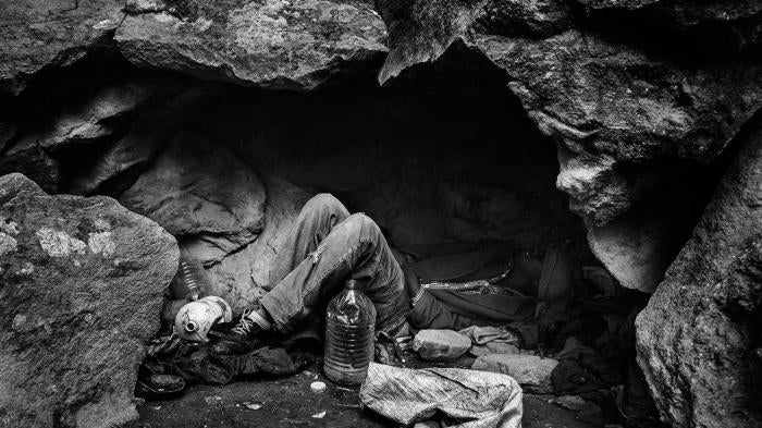 Nador, Morocco, November 2012 – A migrant from Mali lying down in a cave used as shelter. In the forests and mountains that surrounded Nador, groups of Sub-Saharan African migrants survive and wait for the right moment to attempt to cross the border.