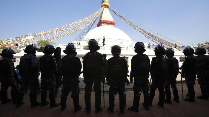 Nepalese police stand guard at the premises of the Boudhanath Stupa after a Tibetan monk self-immolated in Kathmandu on February 13, 2013.