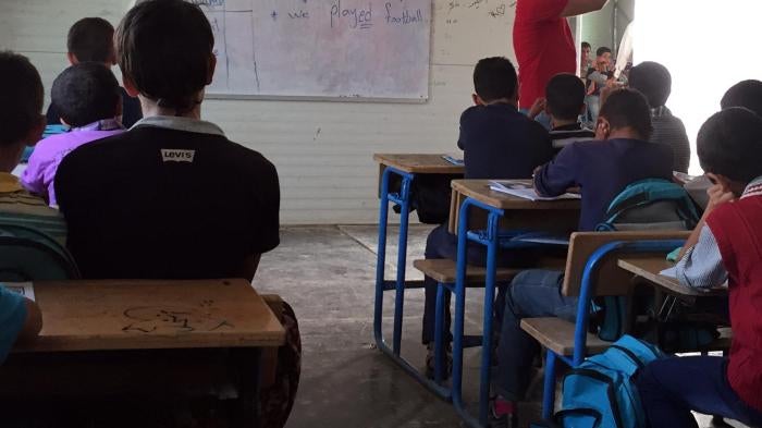 Syrian children attend class in a school in the Zaatari refugee camp in northern Jordan, October 20, 2015. The school taught Syrian girls in the morning and boys in the afternoon, but lacked electricity, heating, and running water. © 2016 Bill Van Esveld/
