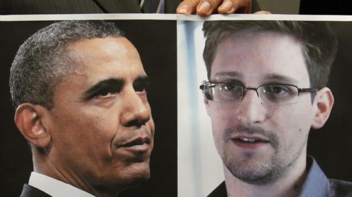 A supporter of Edward Snowden holds a combination photo featuring U.S. President Barack Obama and Edward Snowden, during a news conference in Hong Kong on June 14, 2013.