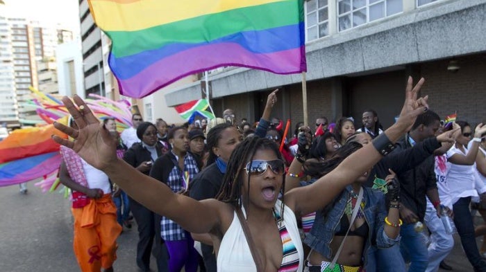 A woman holds her hands up during the Durban Pride parade where several hundred people marched through the Durban city centre in support of gay rights, July 30, 2011.