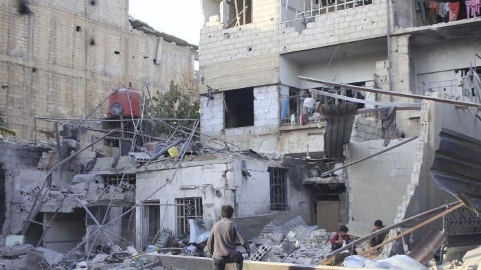 Children in the rubble of damaged buildings in the eastern Damascus suburb of Ghouta, Syria. 