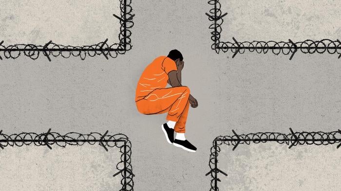 An illustration of a man in a prison uniform lying in fetal position at a crossroads (the roads have barbed wire) 