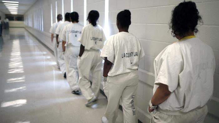 Women walk along a corridor at the Los Angeles County women's jail.
