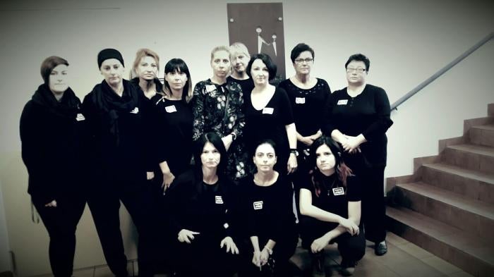 Ewa Wnorowska and her colleagues pose for a photograph in support of women's rights in Poland