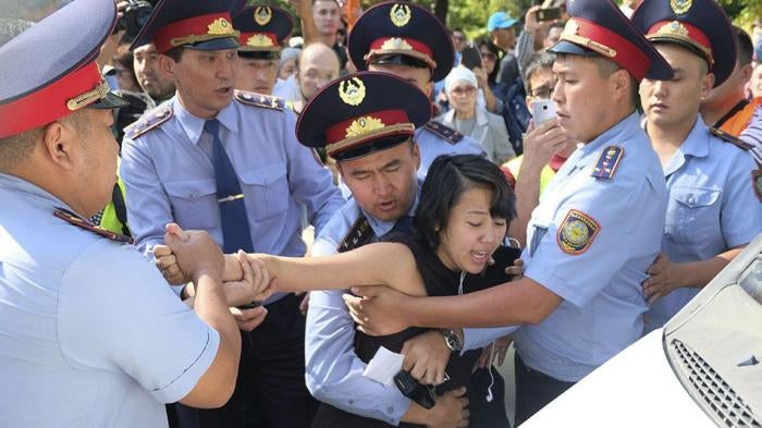 Kazakhstan police officers detain a protester during an opposition rally in Almaty, Kazakhstan.