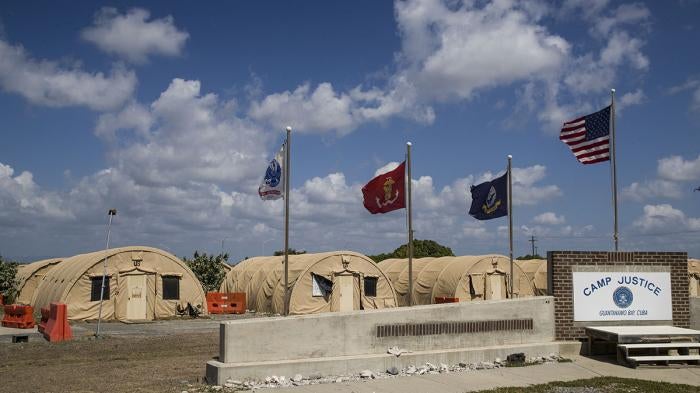 In this photo reviewed by US military officials, flags fly in front of the tents of Camp Justice, April 18, 2019, in Guantanamo Bay Naval Base, Cuba.