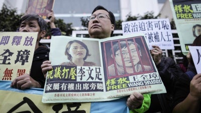 Protesters hold posters of imprisoned lawyer Wang Quanzhang during a demonstration at the China Liaison Office in Hong Kong against the crackdown on human rights lawyers in China, December 26, 2018. 