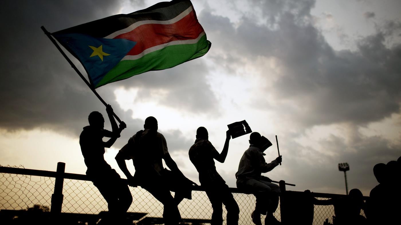Southern Sudanese wave the national flag and cheer at South Sudan's first national soccer match after the country declared its independence, in the capital Juba on July 10, 2011