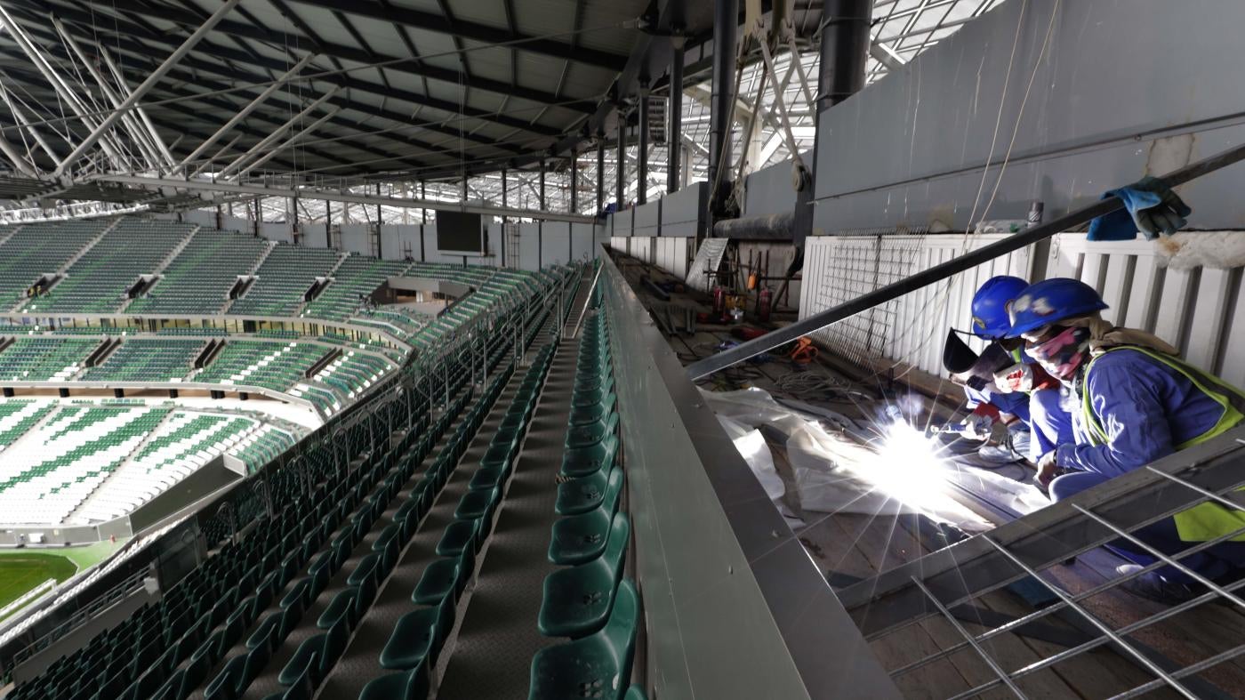 Workers in the seats of a stadium 