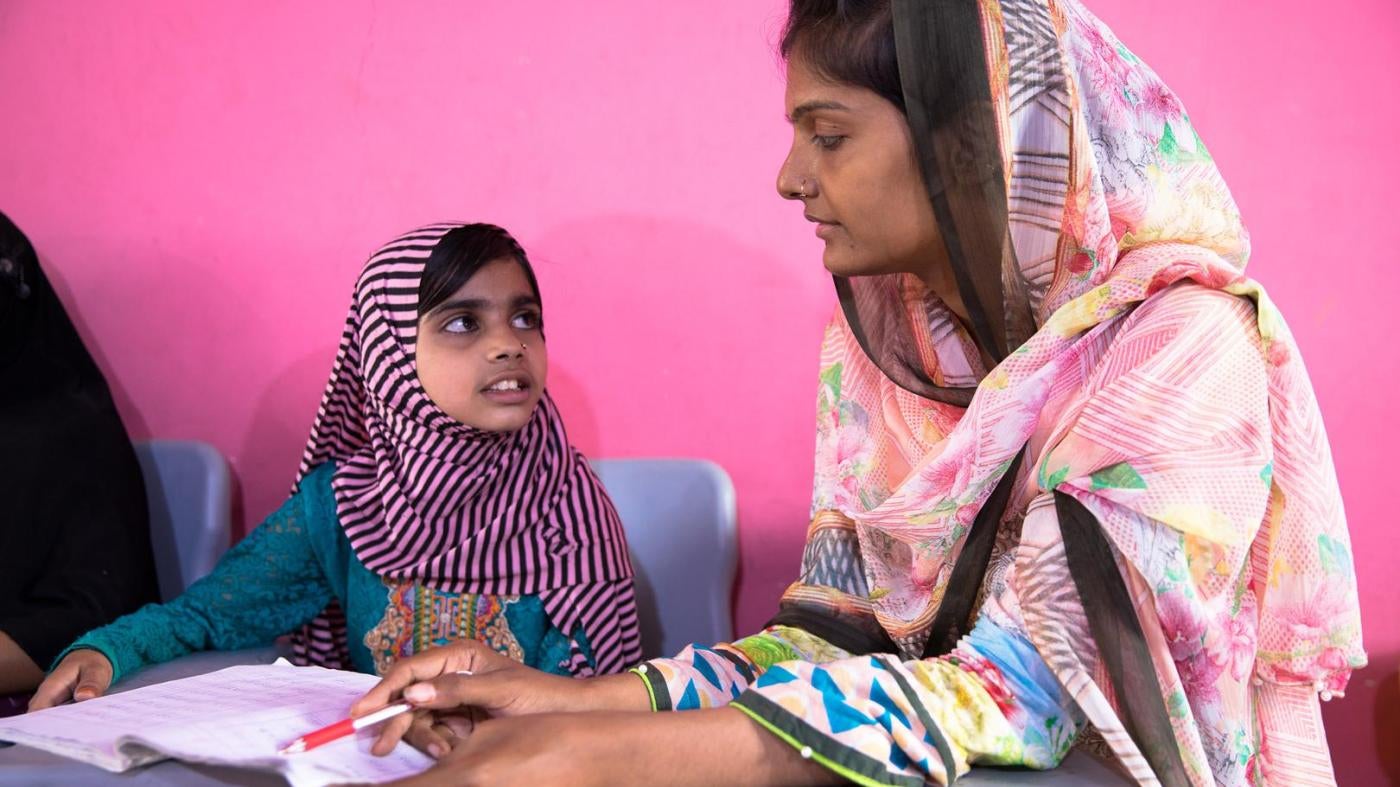Laiba, age eight, with Shazia, the founder of the lyari School. 
