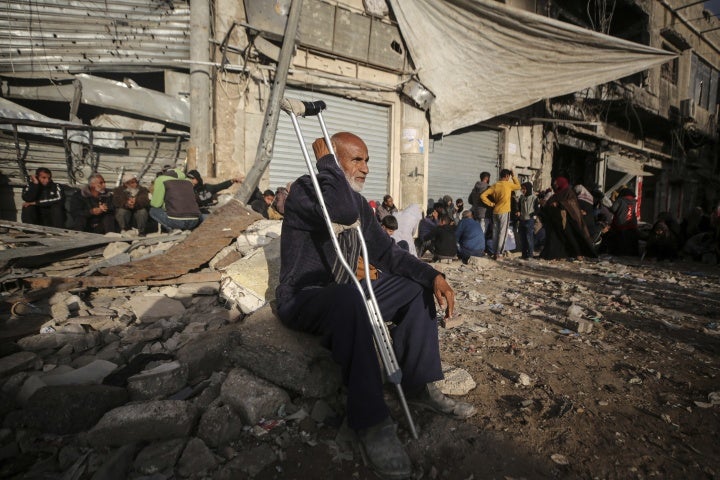 Displaced Palestinians wait outside a bakery for fresh bread in Khan Younis, Gaza, November 19, 2024.