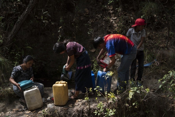 A family collects water in Santa María Chiquimula municipality, Totonicapán department. 