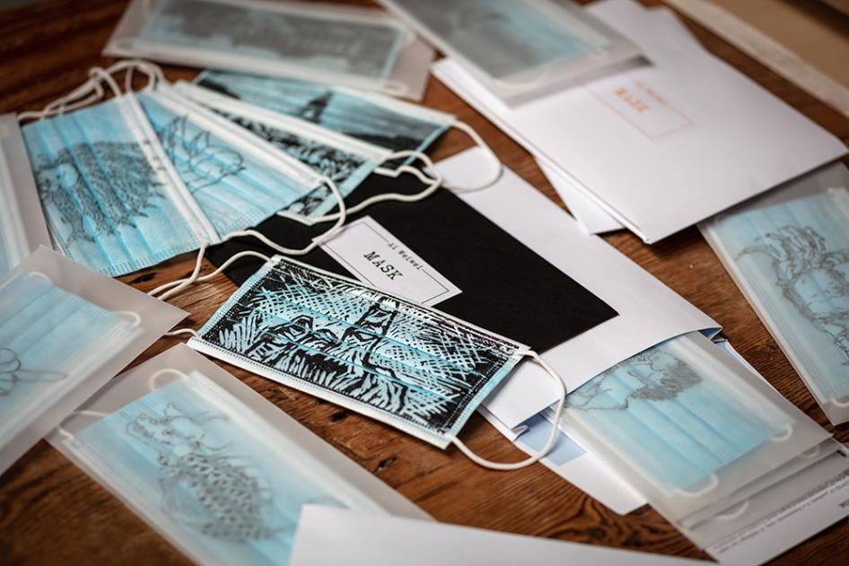 Masks imprinted with artwork by Ai Wei Wei, including symbols of free speech, surveillance, persecution, mass obedience, and defiance. These and others are for sale on eBay for Charity.