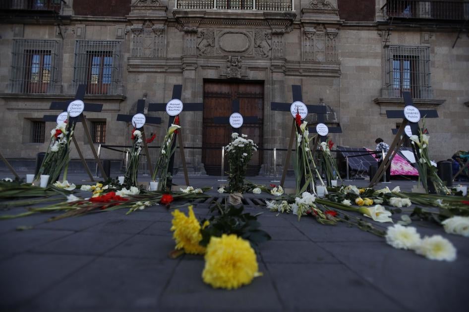 Crosses with the names of 14 journalists and human rights defenders who have been murdered since President Andres Manuel Lopez Obrador took office are pictured in front of the National Palace in Mexico City on Friday, February 22, 2019.