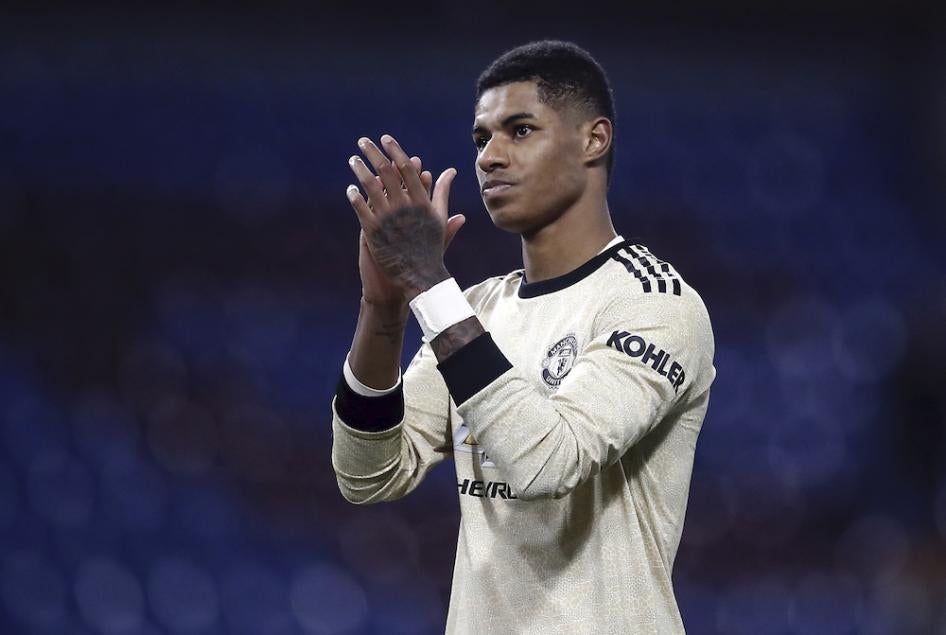 Footballer Marcus Rashford applauds following a game.