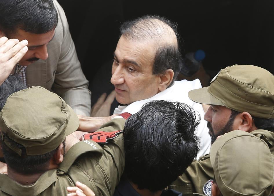 Pakistani police escort Mir Shakilur Rehman to court following his arrest in Lahore, Pakistan, March 13, 2020.
