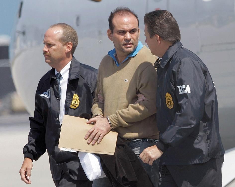 Colombian paramilitary warlord Salvatore Mancuso is escorted by US DEA agents on May 13, 2008 upon his arrival to Opa-locka, Florida.