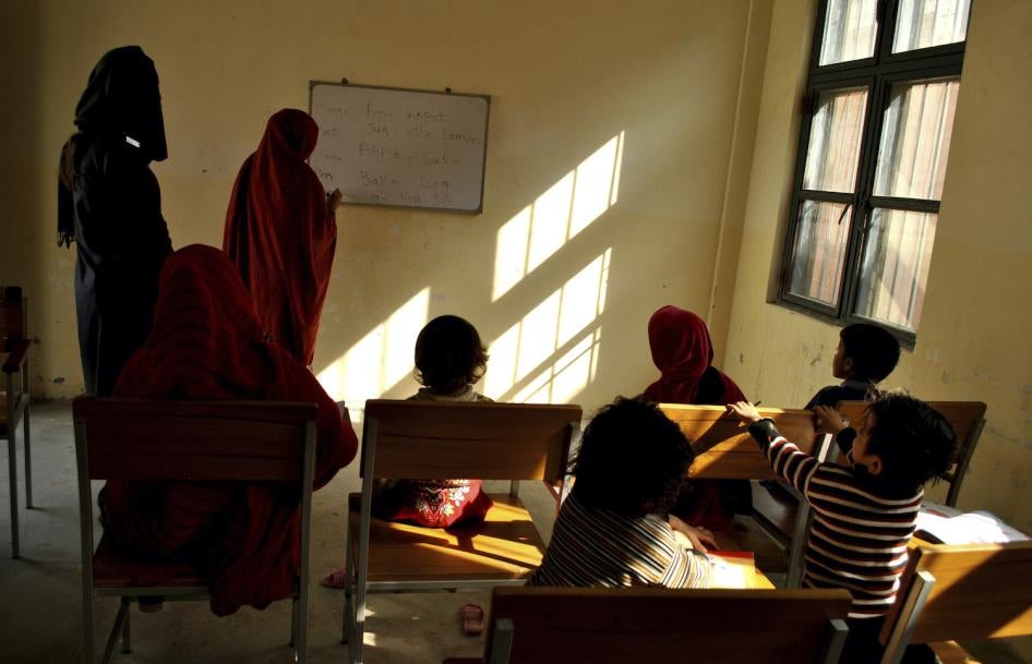 A woman prisoner teaches fellow inmates and their children at a central jail in Mardan, Pakistan, November 8, 2018.