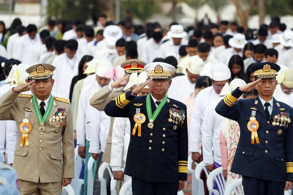 Myanmar military officers salute at their national flag during a ceremony to mark the 72nd anniversary of Independence Day in Naypyitaw, Myanmar. 