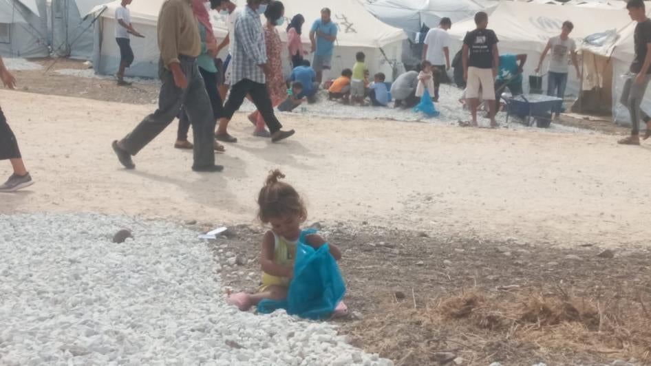 Children playing in the gravel between the tents in Mavrovouni