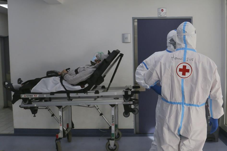 Red Cross volunteers waiting with a coronavirus patient for a place in the intensive care unit of Rafic Hariri University Hospital, Beirut, January 11, 2021.