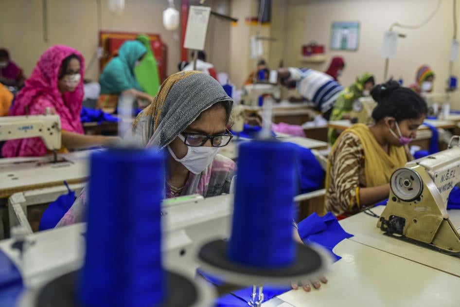 Workers in a factory in Bangladesh wear face masks because of Covid-19