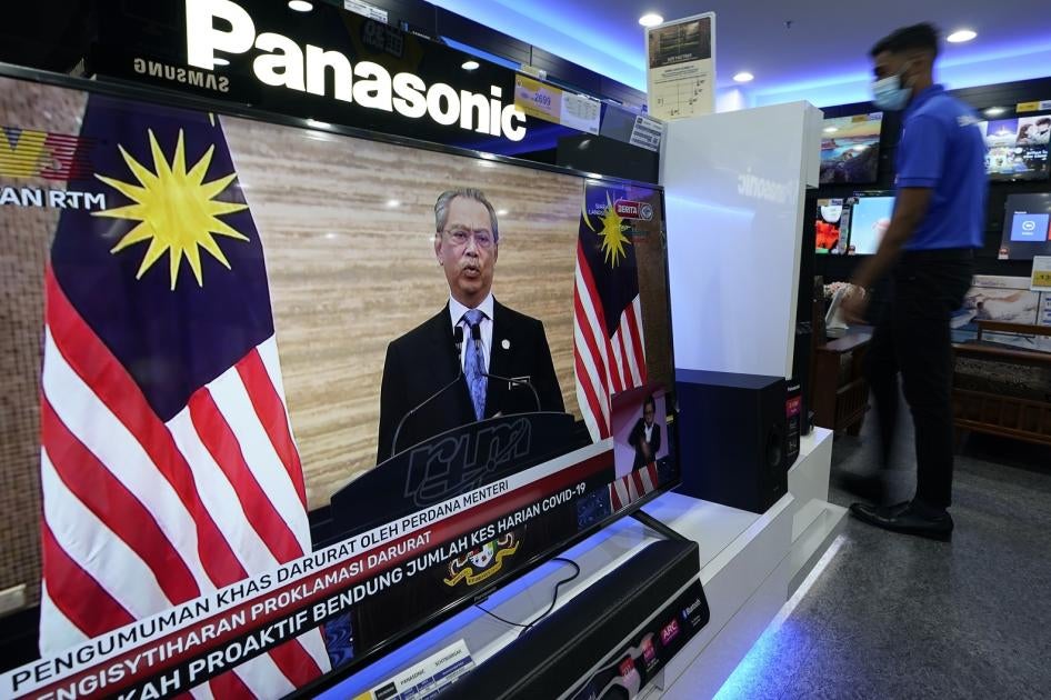 A television shows a live broadcast of Malaysian Prime Minister Muhyiddin Yassin at a shopping outlet in Kuala Lumpur, Malaysia, Tuesday, Jan. 12, 2021. 