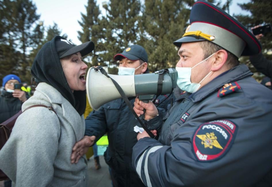 A woman argues with a police officer during a protest in support of jailed opposition leader Alexei Navalny in Ulan-Ude, Russia, April 21, 2021.