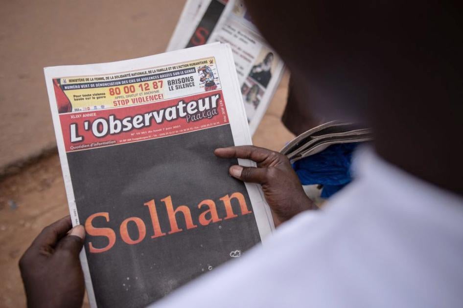 A man reads the L'Observateur Paalga newspaper in Ouagadougou on June 7, 2021, about the attacks that happened in Solhan. 