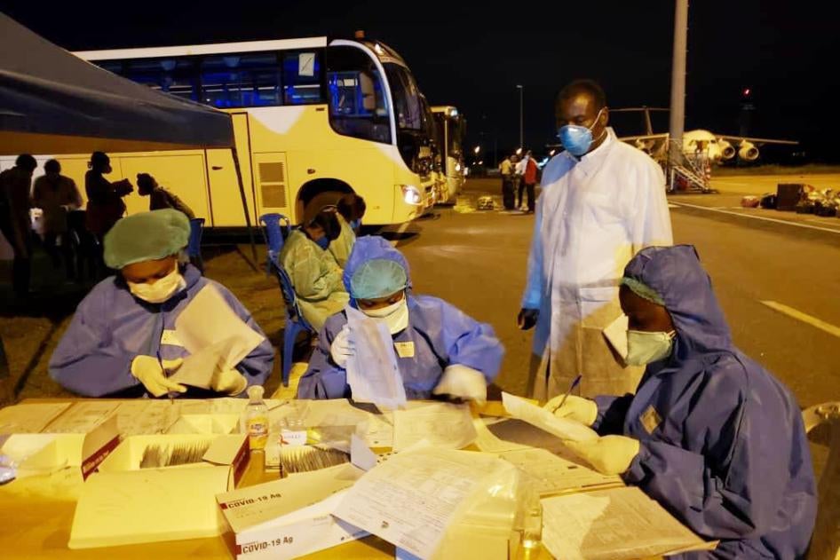CDC Cameroon Associate Director for Program and Science, Dr. Clement Ndongmo, observes Covid-19 testing procedures for passengers arriving at Nsimalen International Airport in Yaoundé. 